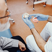Dentist telling patient how dental implants work in Virginia Beach