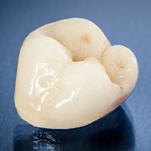 a dental crown against a blue background
