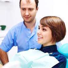 Woman at dentist looking in mirror