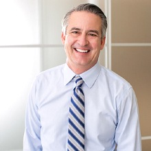 man in dress shirt and tie smiling with dental bridges in Virginia Beach