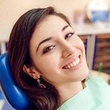 young woman smiling in the dental chair