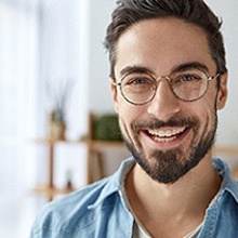 smiling man with a short beard and glasses