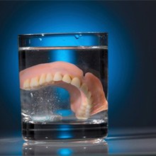 dentures in a glass of water