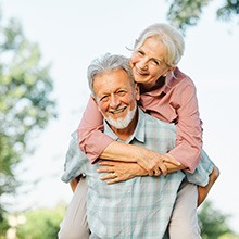 Woman smiling and hugging friend