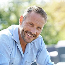 a man smiling with dentures in Virginia Beach