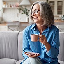 a woman smiling with dentures in Virginia Beach