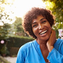 a mature woman smiling with dentures in Virginia Beach