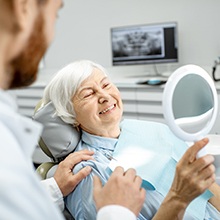 Older woman in dental chair smiling