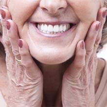 patient smiling after getting dentures in Virginia Beach