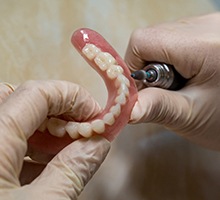 Lab technician carving dentures