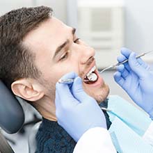 Man visiting his Virginia Beach emergency dentist for checkup