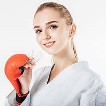 Woman wearing a mouthguard to prevent dental emergencies in Virginia Beach