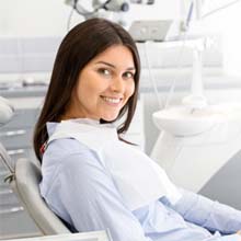 Smiling female patient visiting emergency dentist in Virginia Beach, VA