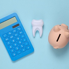 tooth, calculator, piggy bank for cost of tooth extraction Virginia Beach
