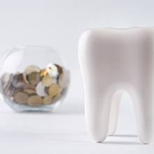 tooth and coins for cost of tooth extraction Virginia Beach