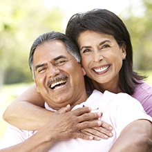 Happy laughing couple with dental implants in Virginia Beach
