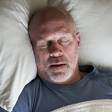 Man fast asleep in bed