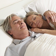 Man and woman sleeping in bed