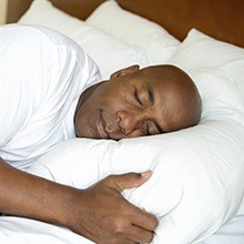 Man sleeping soundly in bed