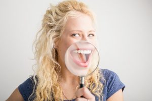 woman magnifying healthy smile