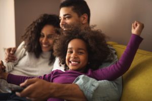 family of three hugging smiling