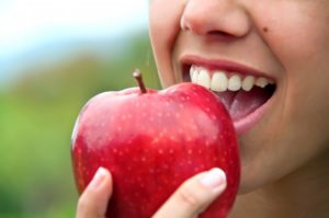 Woman eating apple.