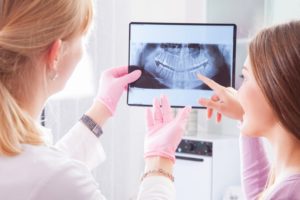 dentist showing a patient their X-ray