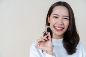 girl holding aligner