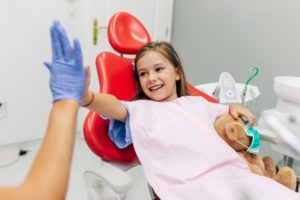 Little girl high-fives her Virginia Beach family dentist 