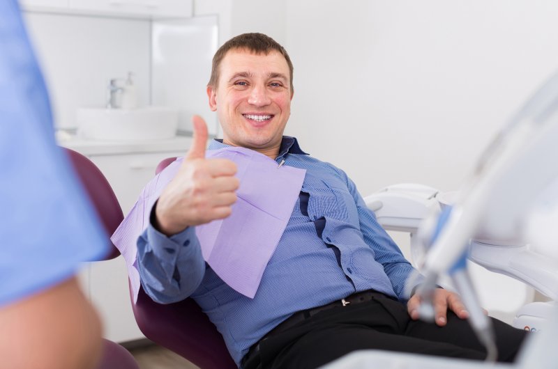 Man giving thumbs up at dentist's appointment