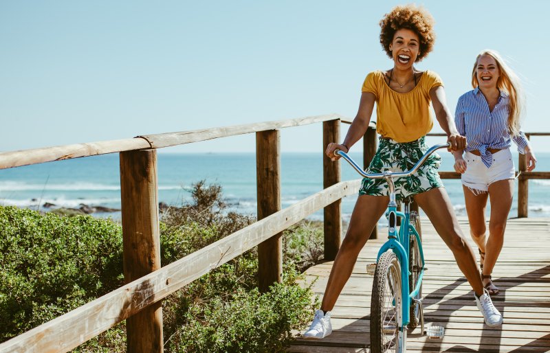 girl biking on boardwalk during summer vacation