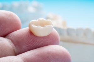 Dentist holding a dental crown